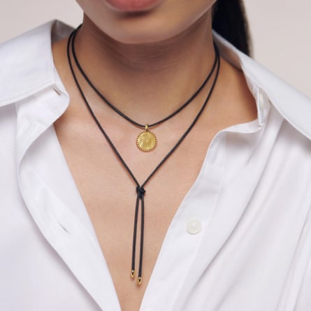 A model wears an open white collar shirt with the Monica Vinader Deia Beaded Pendant Black Cord Necklace