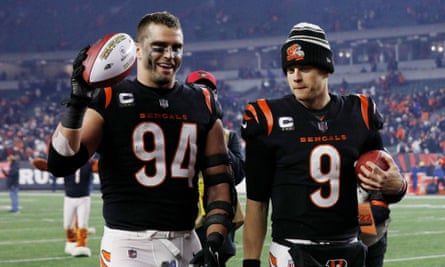 Sam Hubbard (left) with the game ball alongside Joe Burrow after the Bengals’ win on Sunday night