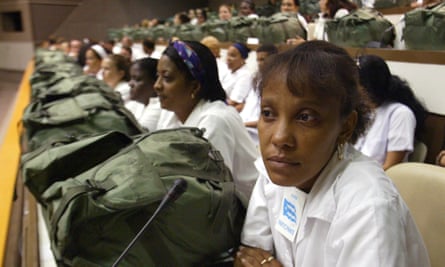 Hundreds of doctors with backpacks loaded with medications meet in in the Karl Marx theatre in September 2005, in Havana, Cuba.