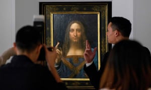 People take photos of Leonardo da Vinci's Salvator Mundi painting