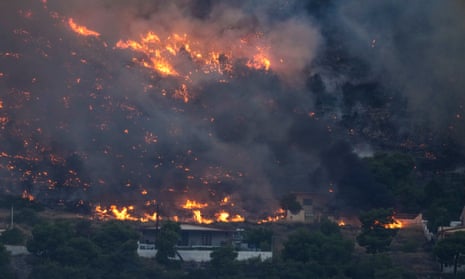 Fire approaches houses in Kalamaki near Agioi Theodori about 60 Kilometres west of Athens , on Monday, 17 July 2023.