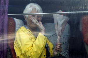 A passenger waves from a bus after she disembarked from the MS Westerdam, at the port of Sihanoukville in Cambodia on Friday.