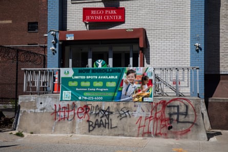 antisemitic graffiti is spray-painted on outside of a synagogue