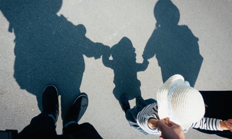 silhouette of a family on pavement