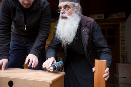 A monk teaches a new arrival about carpentry.