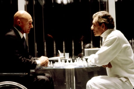 Patrick Stewart and Ian McKellen sit facing each other, a chess set between them
