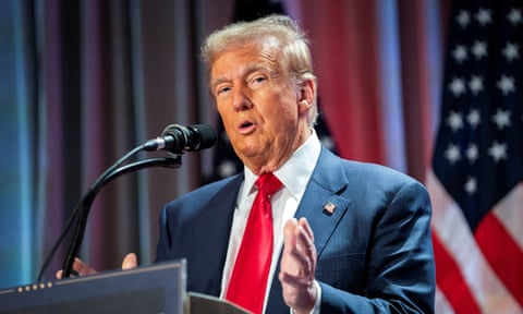 Trump speaking in to a mic attached to a lectern