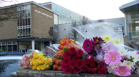 Floral tributes in foreground with the school behind