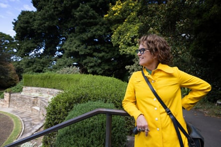 Crabb leans on a railing beside a hedge