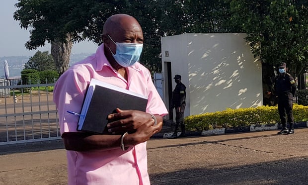 Paul Rusesabagina walks in handcuffs to a courtroom in Kigali in February 2021.