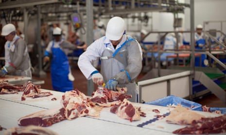 Butchers at work at a meat processing plant in the UK.