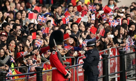 Smiling crowd waving flags
