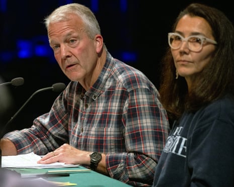 a man speaks next to a woman