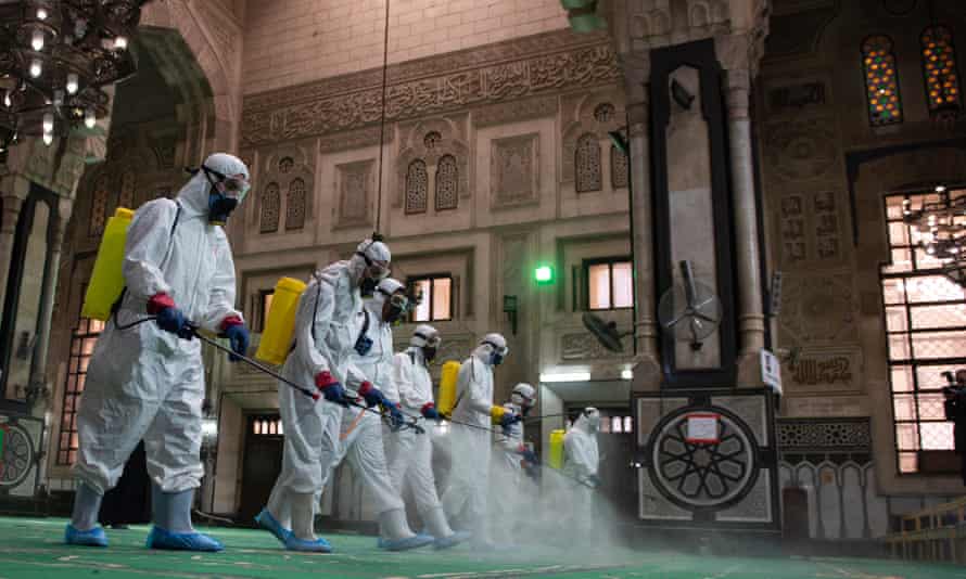 Workers disinfecting the al-Fateh mosque in Cairo
