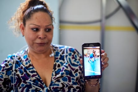 In a migrants shelter in Tijuana, Laura Lara Romero shows a video of her daughter, who is still in the US.