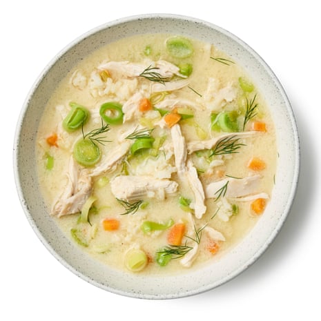 A bowlful of avgolemono soup, with shards of chicken, and bits of carrot, leeks and dill