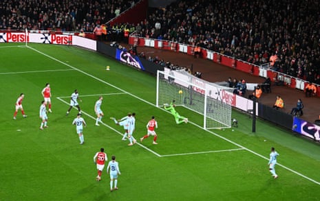 Mikel Merino of Arsenal scores his team's first goal past Brentford keeper Caoimhin Kelleher.