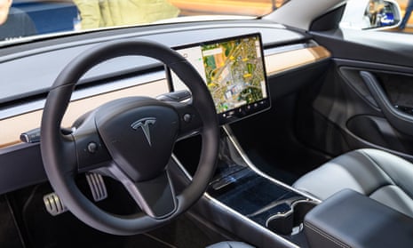 The Tesla Model 3 interior with a large touch screen on the dashboard. The Model 3 is fitted with a full self-driving system. 