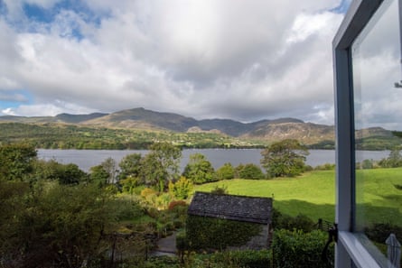 Stunning view of a lake and mountains from an open casement window