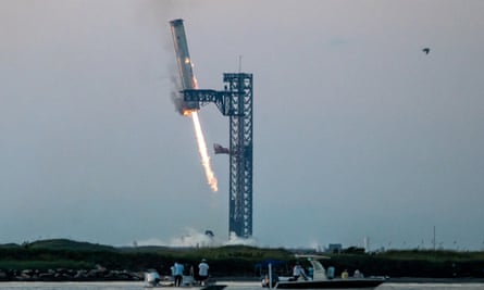 Starship’s booster is grappled at the launch pad.