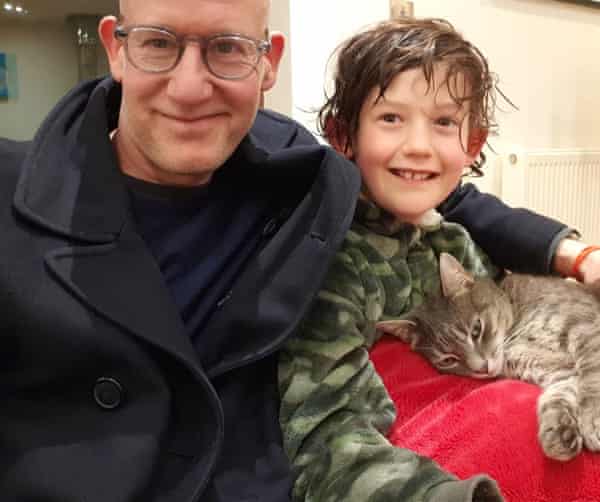 Harry Borden with his son and their pet cat.