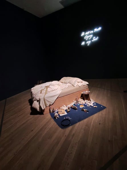 Tracey Emin’s My Bed, which shows a messy double bed and a blue mat on the floor covered in quotidian paraphernalia