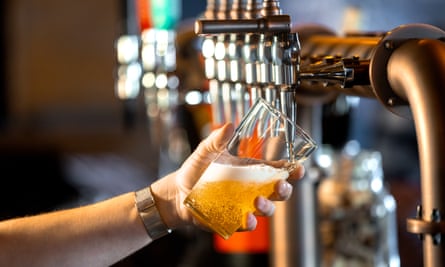 Hand holding a pint glass at an angle