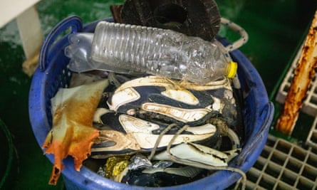 A bucket of rubbish, including trainers from a container which sank 20 years ago.