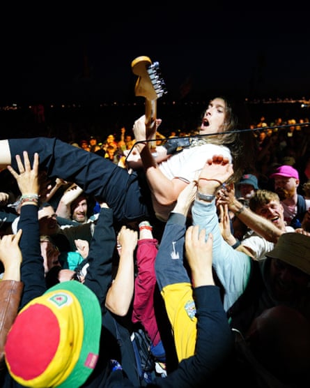 Idles’ guitarist performing in the Other Stage crowd at Glastonbury 2024.