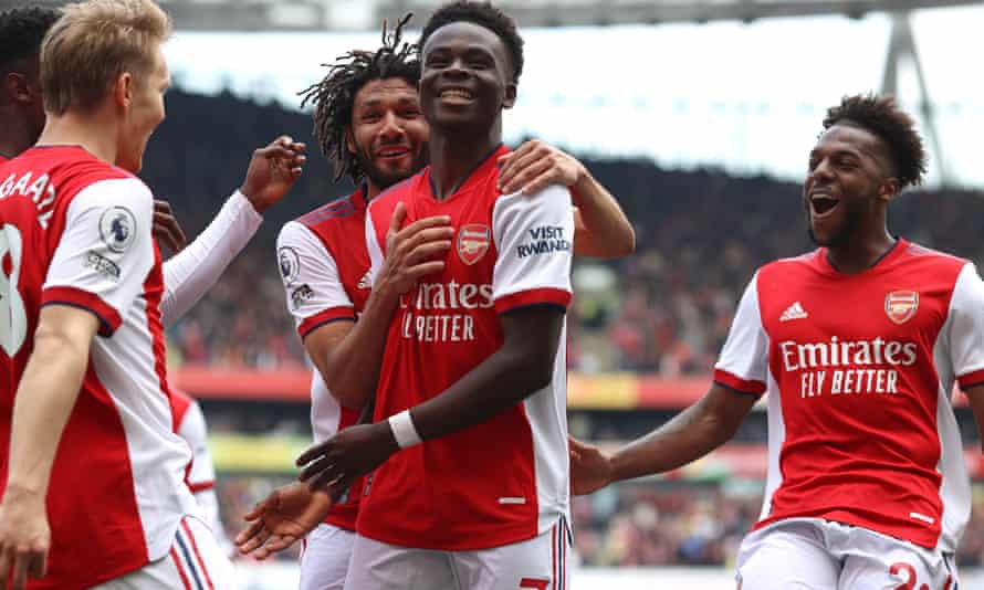 Bukayo Saka is congratulated by teammates after scoring from the spot.
