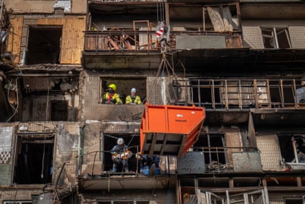 Rescuers clean up rubble and debris from damaged residential building