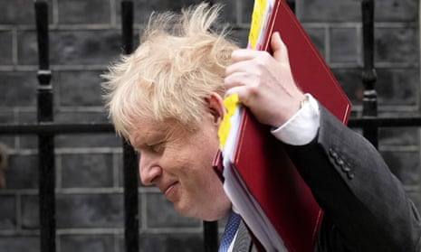 Boris Johnson waves his folder at the media as he passes the gates of 10 Downing Street