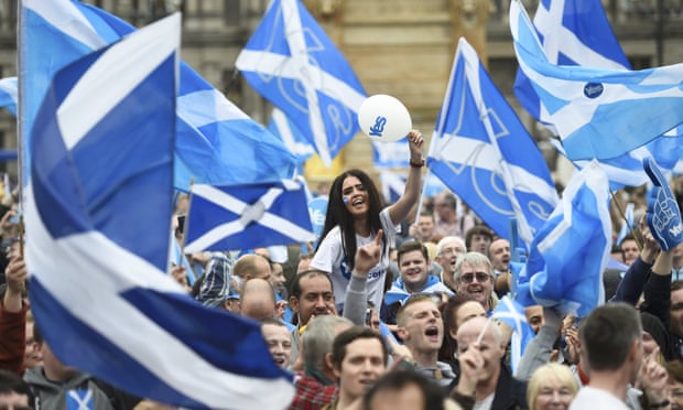 Campaigners wave Scottish flags at a yes campaign rally in Glasgow, Scotland, in September 2014