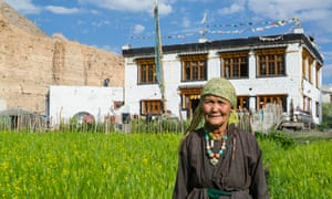 Portrait of a local woman by her homestay in Markha Valley, by her cereal plot. The woman wears traditional mountain wool clothing.