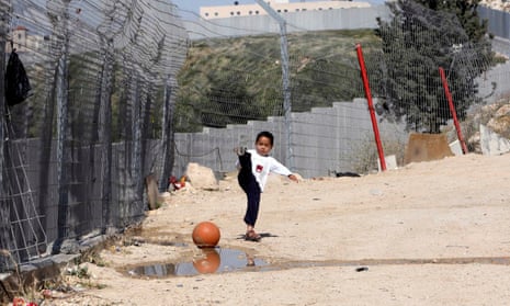 A Palestinian boy plays outside his house in the Shuafat refugee camp.