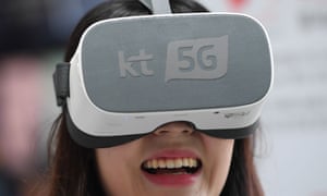 An employee demonstrates 5G services on a VR device for South Korean telecom operator KT.