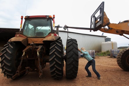 Jemima Penfold manoeuvres a tyre onto a tractor