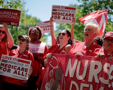 women hold signs in support of 'Medicare for all'