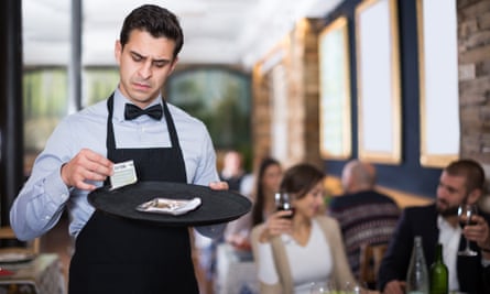Waiter looking dissatisfied with tip.
