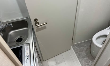 The kitchenette in this Tokyo micro-apartment sits right opposite the toilet