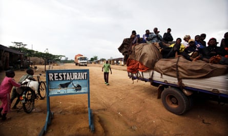 A truck loaded with passengers stops outside a restaurant serving bush meat, in the town of Epulu, Democratic Republic of Congo.