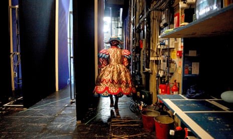 A woman in costume back stage at a play