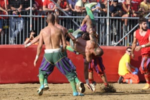 Players take part in the game of the ‘Calcio Storico Fiorentino’, a traditional soccer match played in costume, in Florence, Italy
