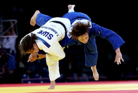 Judokas Natsumi Tsunoda (blue) of Japan and Tara Babulfath of Sweden in action at the Paris Olympics