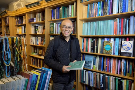 Yusry holding a book and smiling