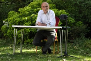 Cummings sitting at table in No 10 garden