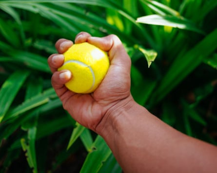 Hand squeezing a tennis ball