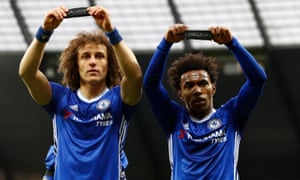 Chelsea’s Willian celebrates scoring their second goal with David Luiz as they hold up theri armbands in respect for the victims of the Colombia plane crash.