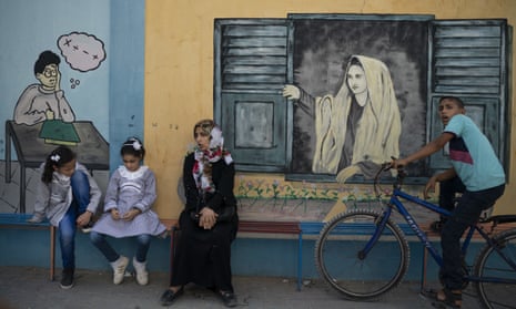 Two Palestinian girls sit outside a UNRWA school before their first day of class in Gaza City on Wednesday.