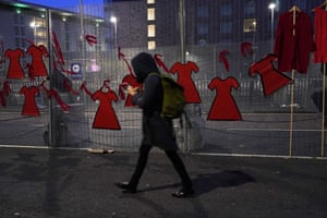 A person walks past a mural near the summit in Glasgow